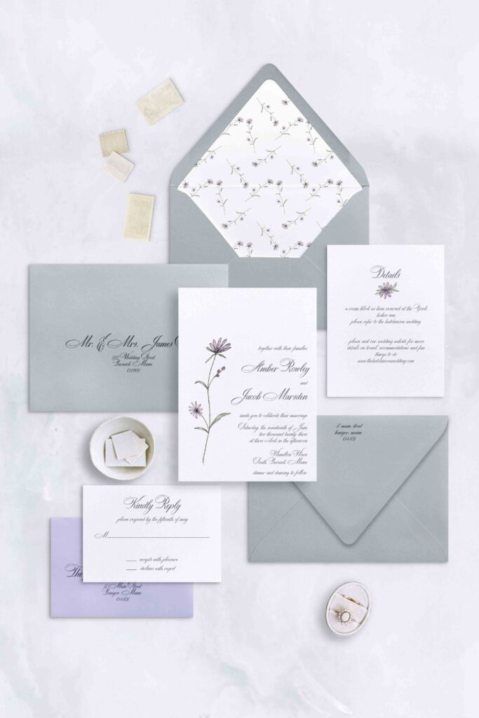 Simple floral watercolor invitation with a single flower and traditional script